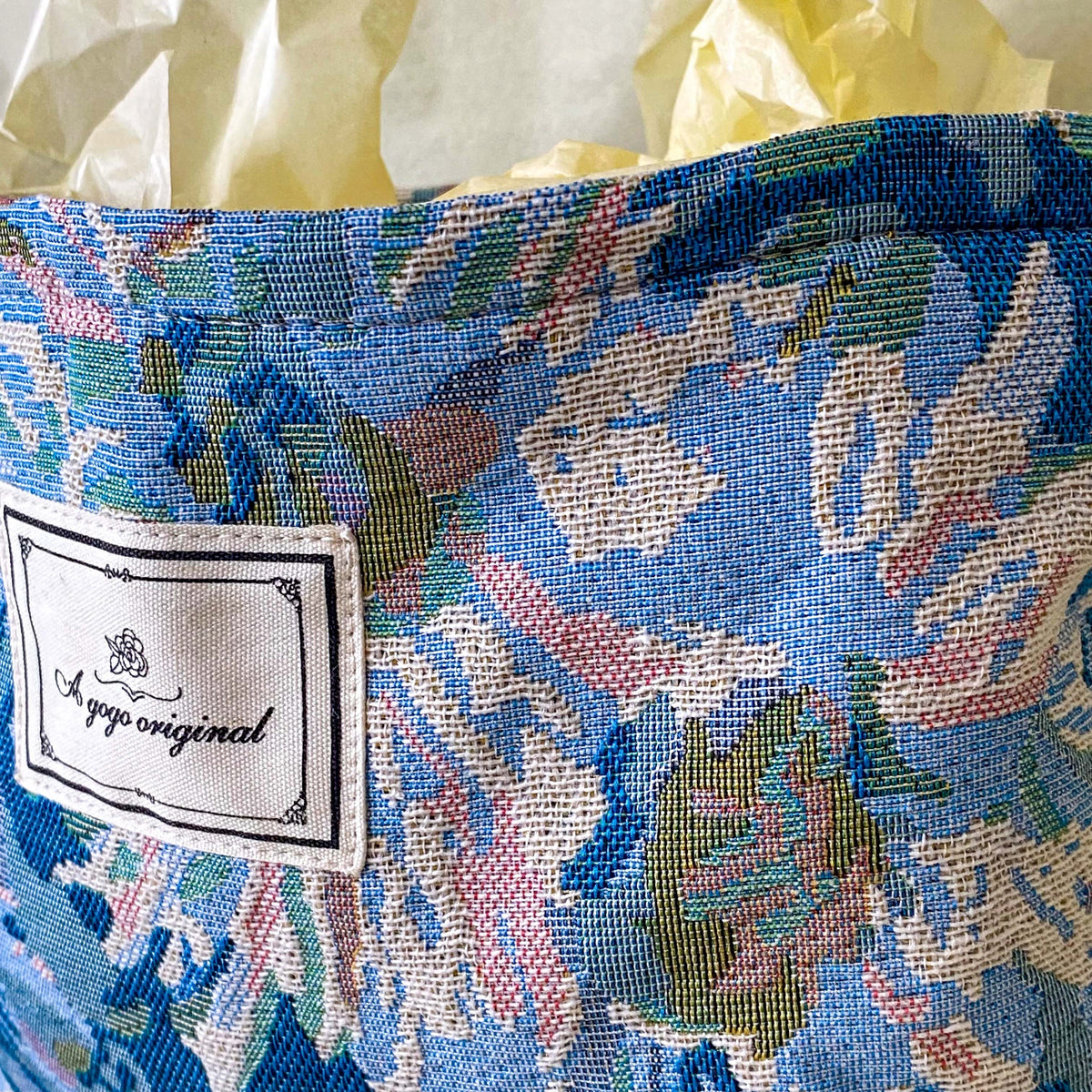 blue, pale pink and turquoise chrysanthemum tapestry pouch with woven floral fabric, cream lining, concealed zip closure and gusseted base. Botanical make up cosmetic pouch, large pencil case or journaling bag. Uk gifts shop. Gifts for flower lovers.