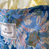 blue, pale pink and turquoise chrysanthemum tapestry pouch with woven floral fabric, cream lining, concealed zip closure and gusseted base. Botanical make up cosmetic pouch, large pencil case or journaling bag. Uk gifts shop. Gifts for flower lovers.