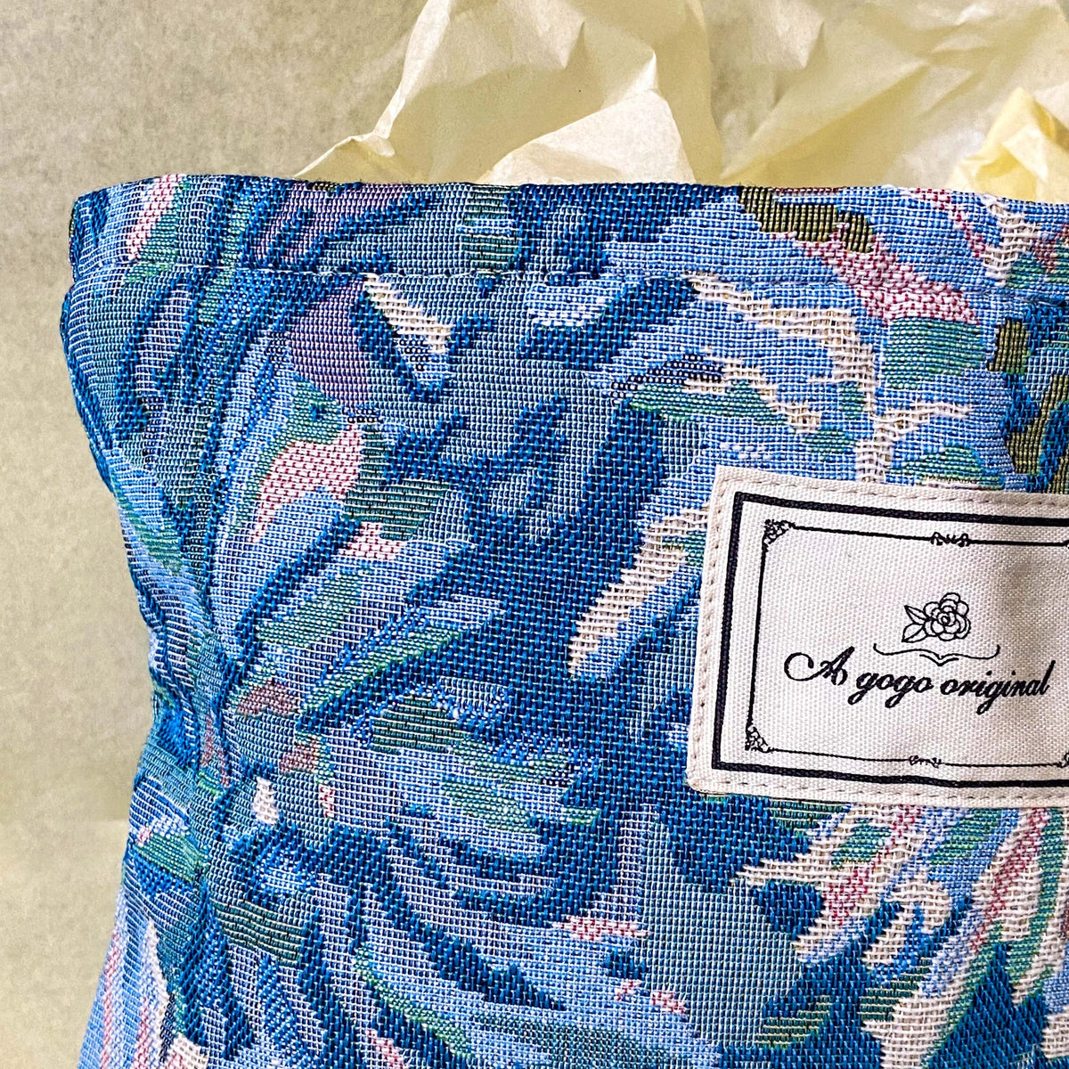 blue, pale pink and turquoise chrysanthemum tapestry pouch with woven floral fabric, cream lining, concealed zip closure and gusseted base. Botanical make up cosmetic pouch, large pencil case or journaling bag. Uk gifts shop. Gifts for flower lovers.