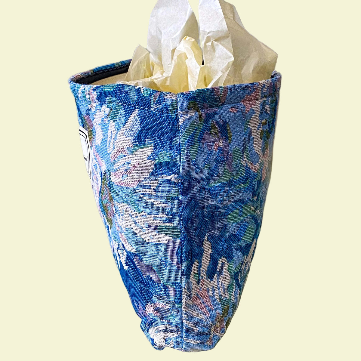 blue, pale pink and turquoise chrysanthemum tapestry pouch with woven floral fabric, cream lining, concealed zip closure and gusseted base. Botanical make up cosmetic pouch, large pencil case or journaling bag. Uk gifts shop. Gifts for flower lovers.