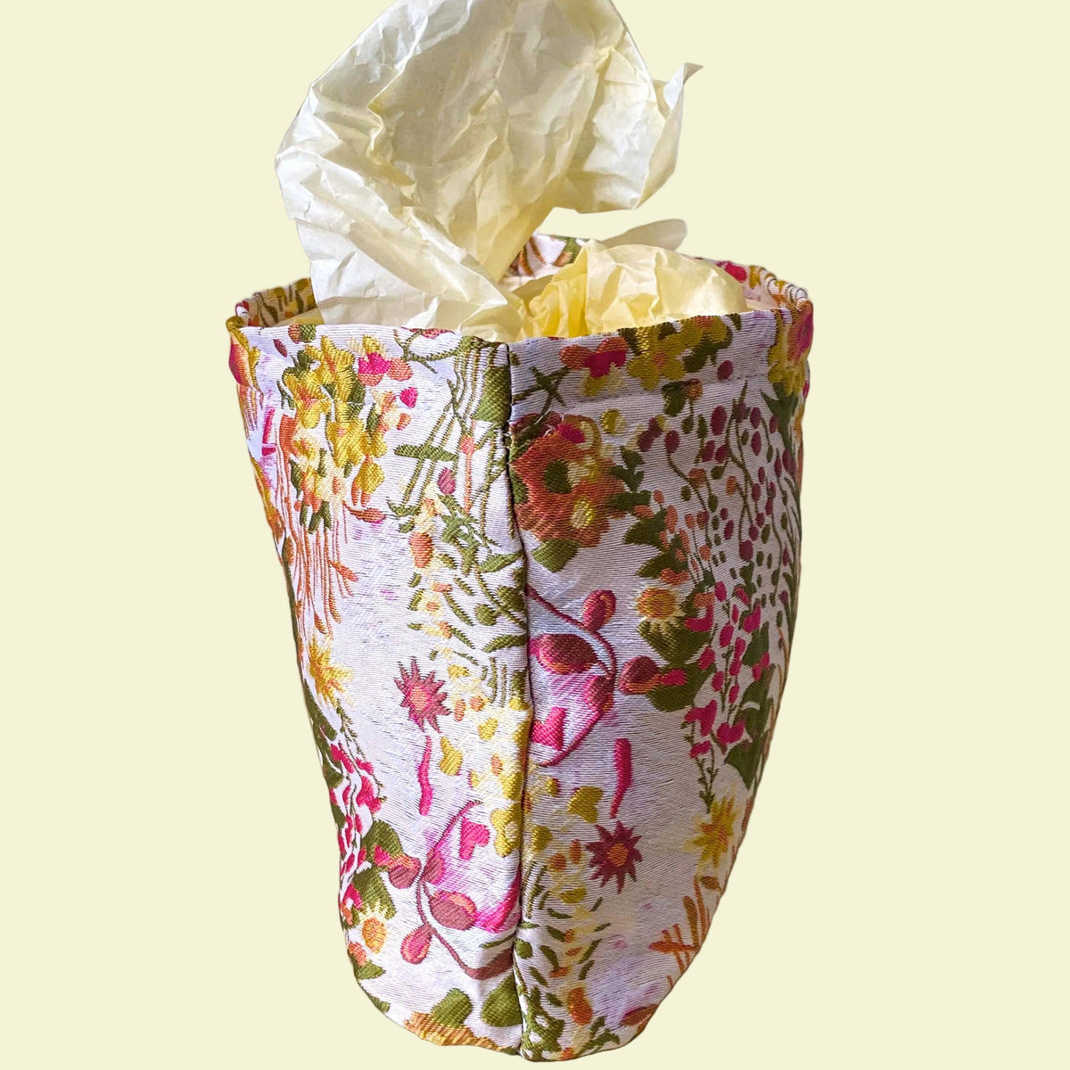 wildflower meadow tapestry pouch with colourful woven floral design including daisies, cream lining, concealed zip closure and gusseted base. Cream, orange, lemon, soft green and white design. Subtle sheen. Large cosmetic bag or toiletry pouch. Uk botanical gift shop.