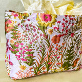 wildflower meadow tapestry pouch with colourful woven floral design including daisies, cream lining, concealed zip closure and gusseted base. Cream, orange, lemon, soft green and white design. Subtle sheen. Large cosmetic bag or toiletry pouch. Uk botanical gift shop.