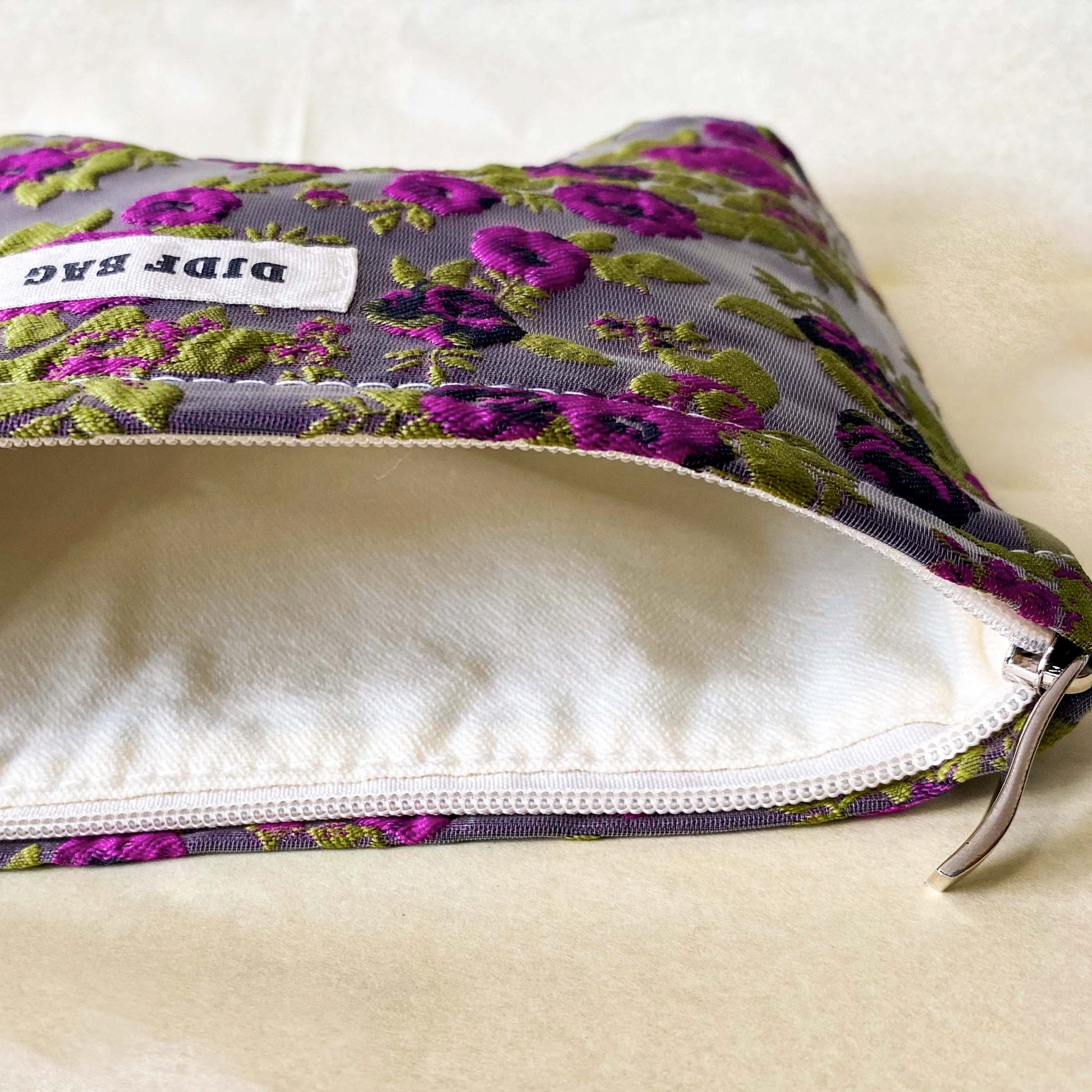 purple and green tapestry cometic pouch with woven satin-finish fabric with roses design, concealed zip, cream lining and gusseted base. Victorian inspired floral gift ideas from uk shop. museum quality cosmetic bag.