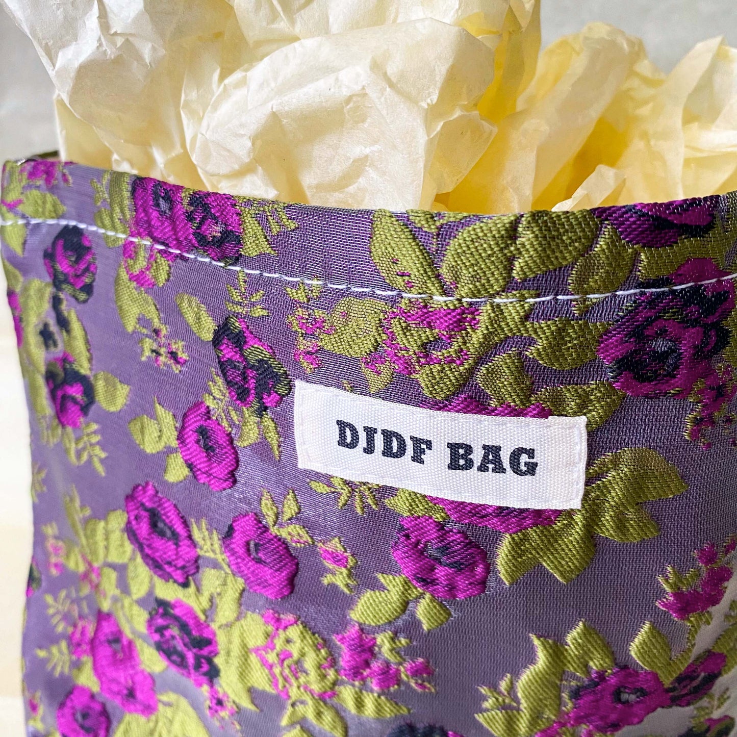 purple and green tapestry cometic pouch with woven satin-finish fabric with roses design, concealed zip, cream lining and gusseted base. Victorian inspired floral gift ideas from uk shop. museum quality cosmetic bag.