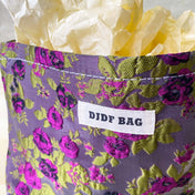 purple and green tapestry cometic pouch with woven satin-finish fabric with roses design, concealed zip, cream lining and gusseted base. Victorian inspired floral gift ideas from uk shop. museum quality cosmetic bag.