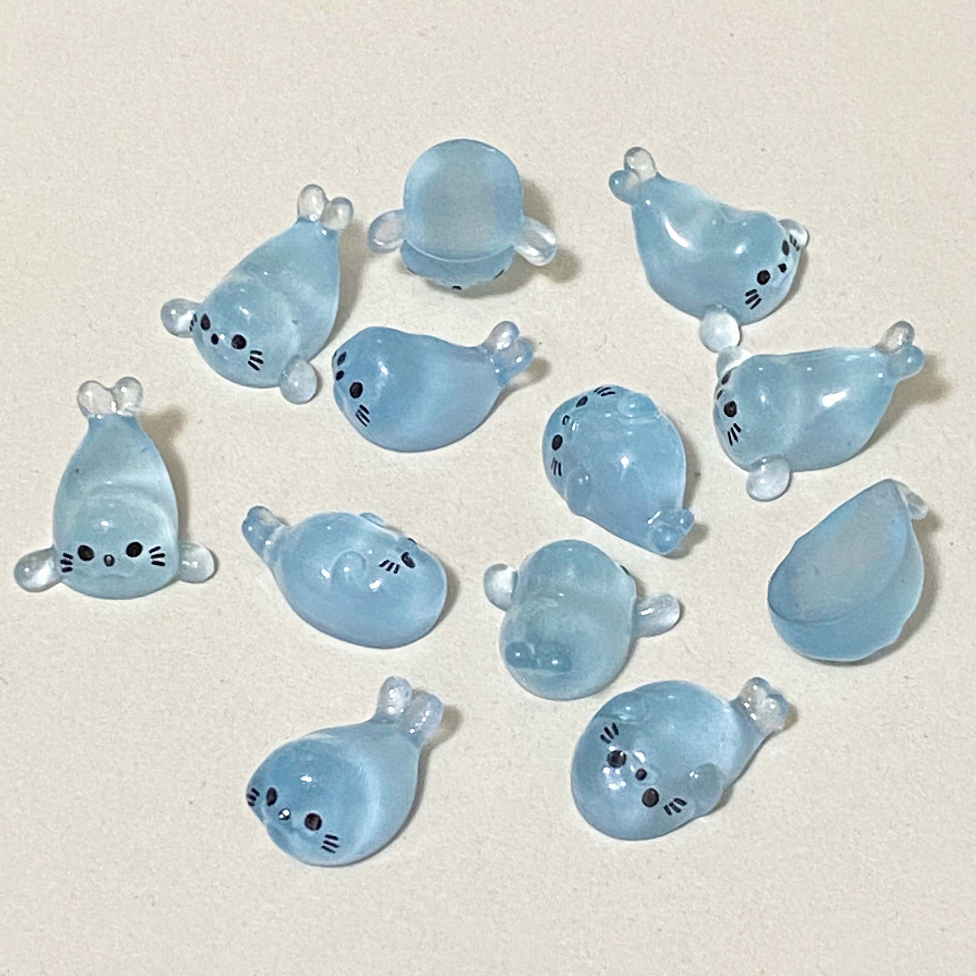 baby seal light blue resin figurines on a cream background