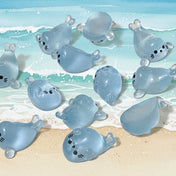 baby seal light blue resin figurines on a cream background 