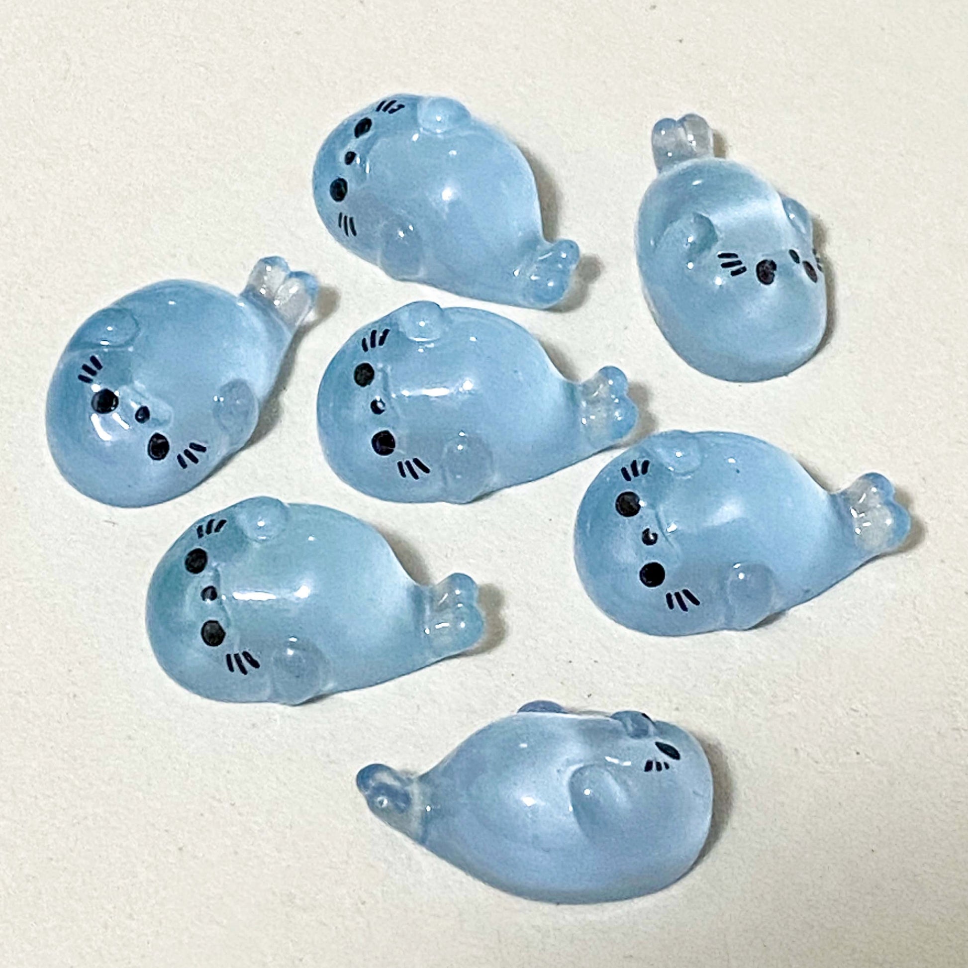 baby seal light blue resin figurines on a cream background