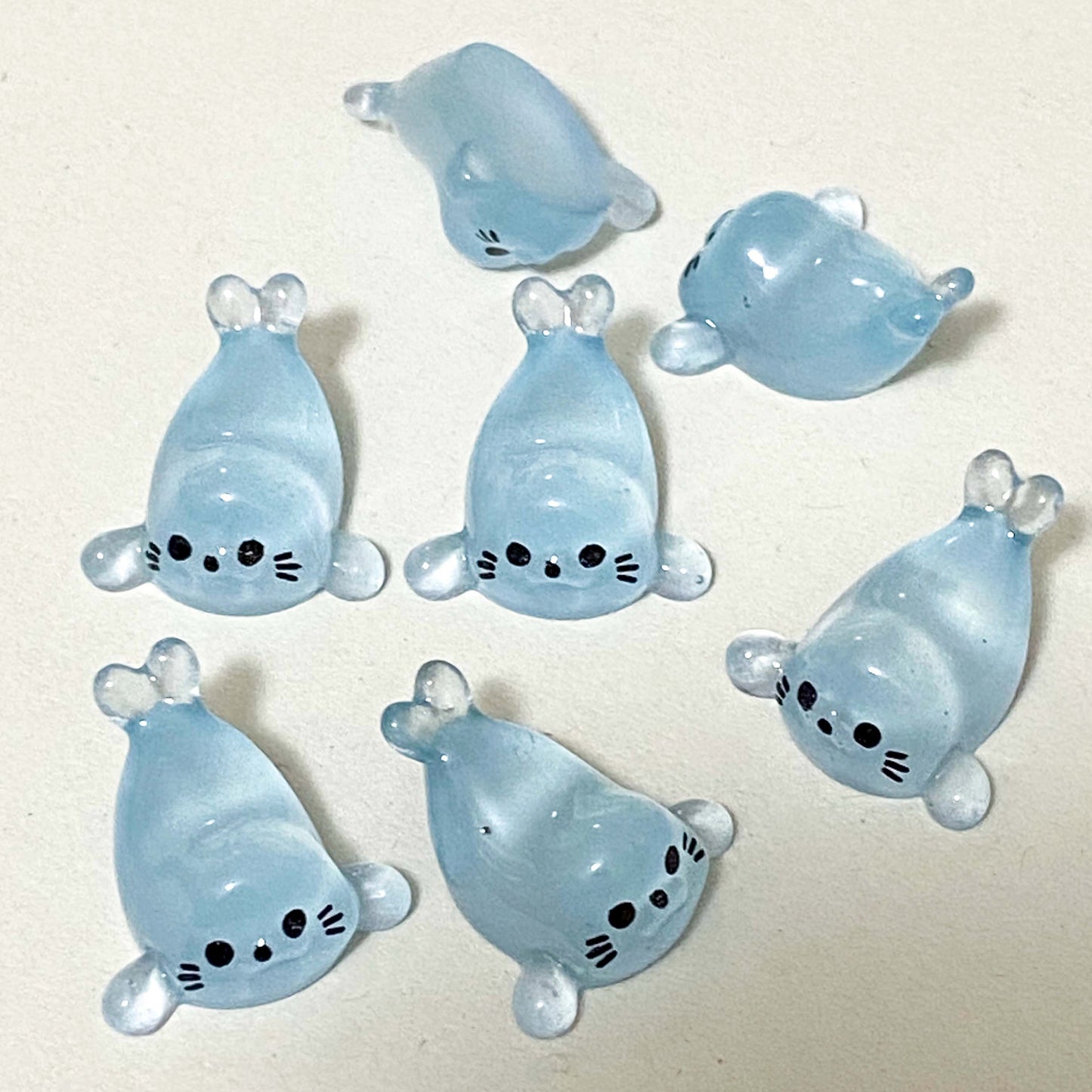 baby seal light blue resin figurines on a cream background
