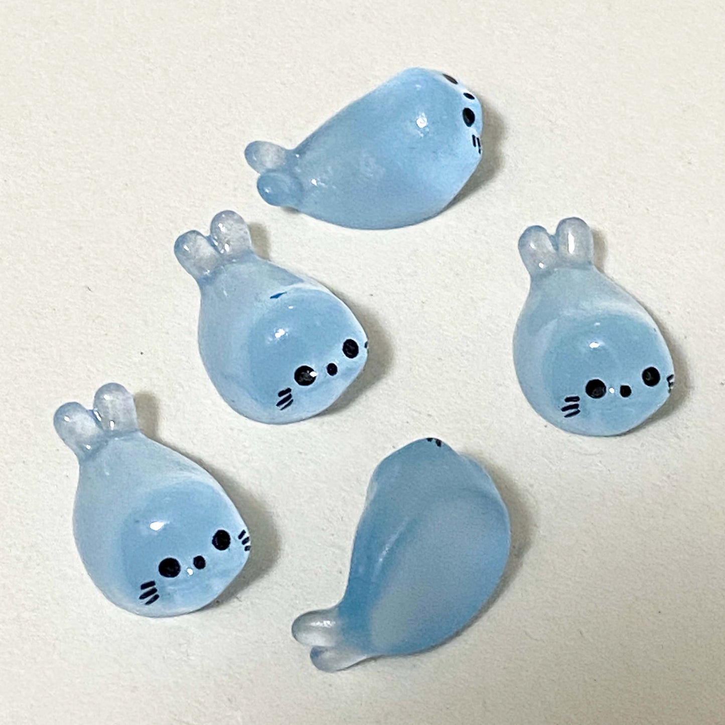 baby seal light blue resin figurines on a cream background