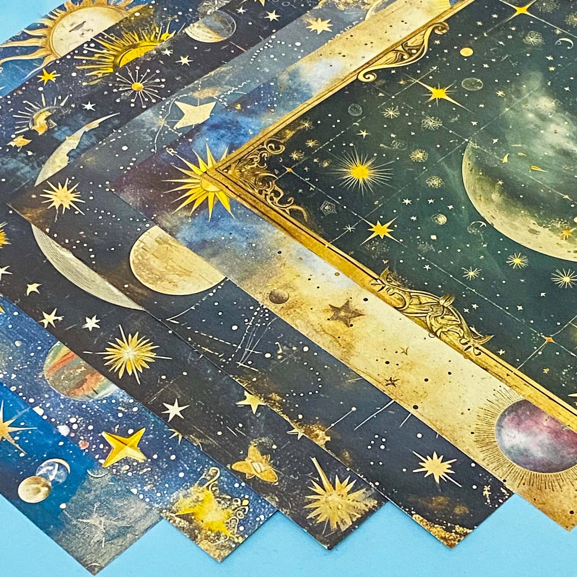 celestial scrapbook paper pack with dark blue sky night designs featuring gold stars, moons, planets and vintage astrology illustrations