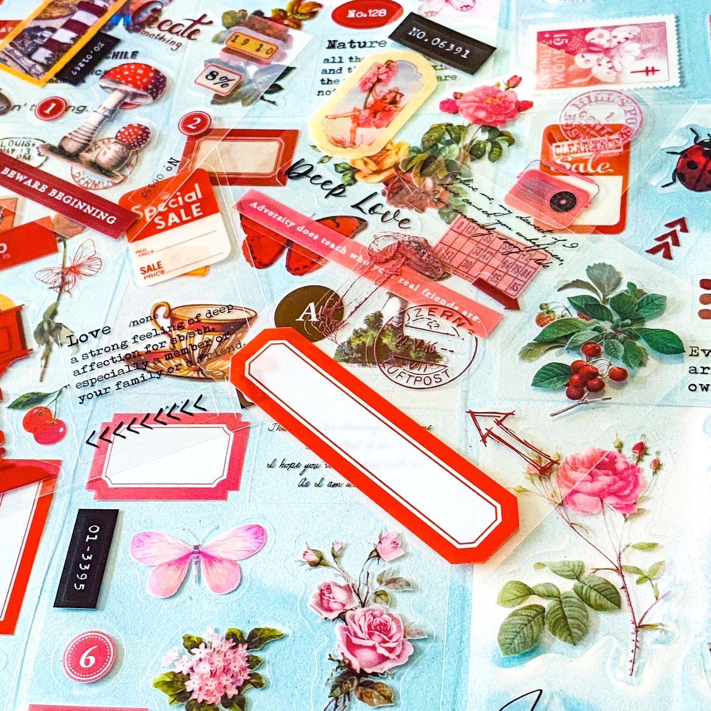 collection of 25 sheets of clear stickers featuring vintage botanical illustrations, flowers, butterflies, labels, borders and tickets with a pink and red theme
