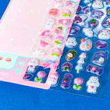 close up of glossy raised 3d domed stickers with cute bunnies and strawberries