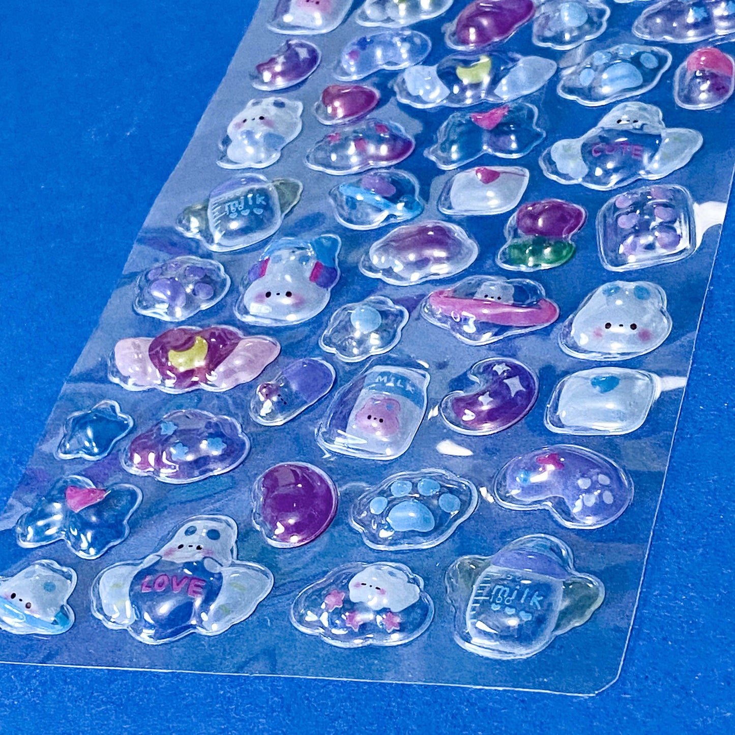 close up of domed plastic stickers with kawaii bunnies strawberries and foods