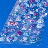 close up of domed plastic stickers with kawaii bunnies strawberries and foods