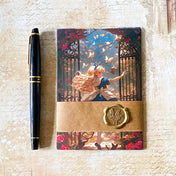 alice in wonderland postcard set wrapped in a kraft belly band with wax seal sticker, featuring alice running through the garden gates to wonderland