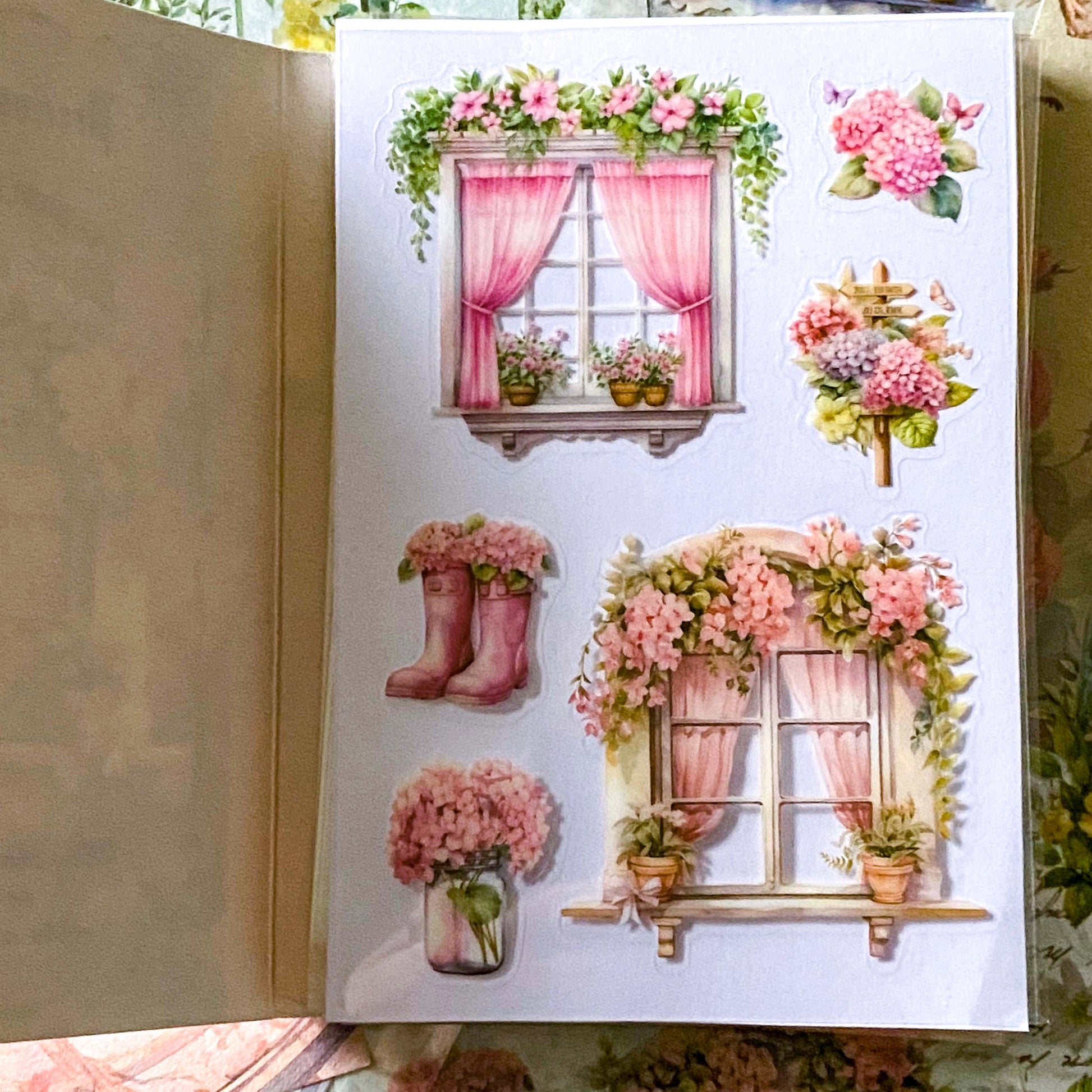 close up of a pink windows and floral stickers on clear plastic PET film in a book