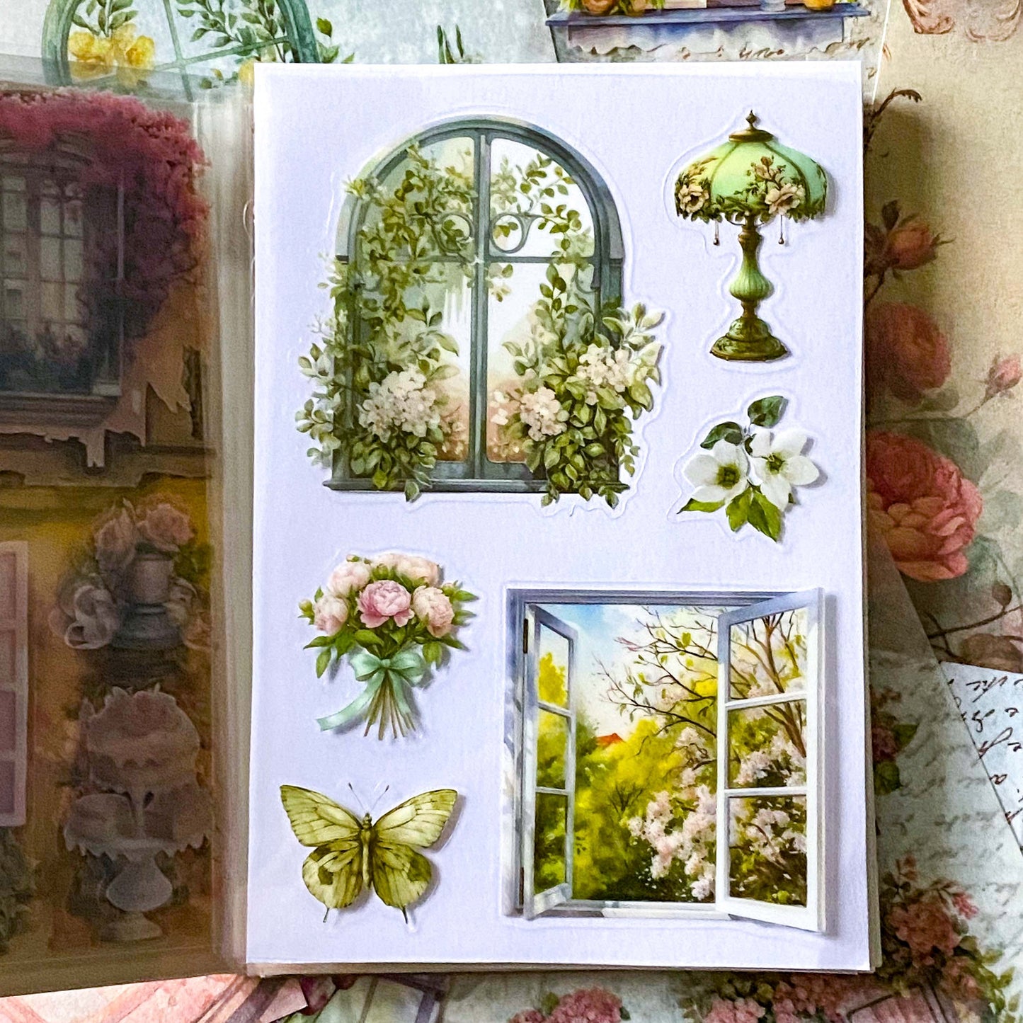 close up of white, cream and green window stickers with floral details in vintage style
