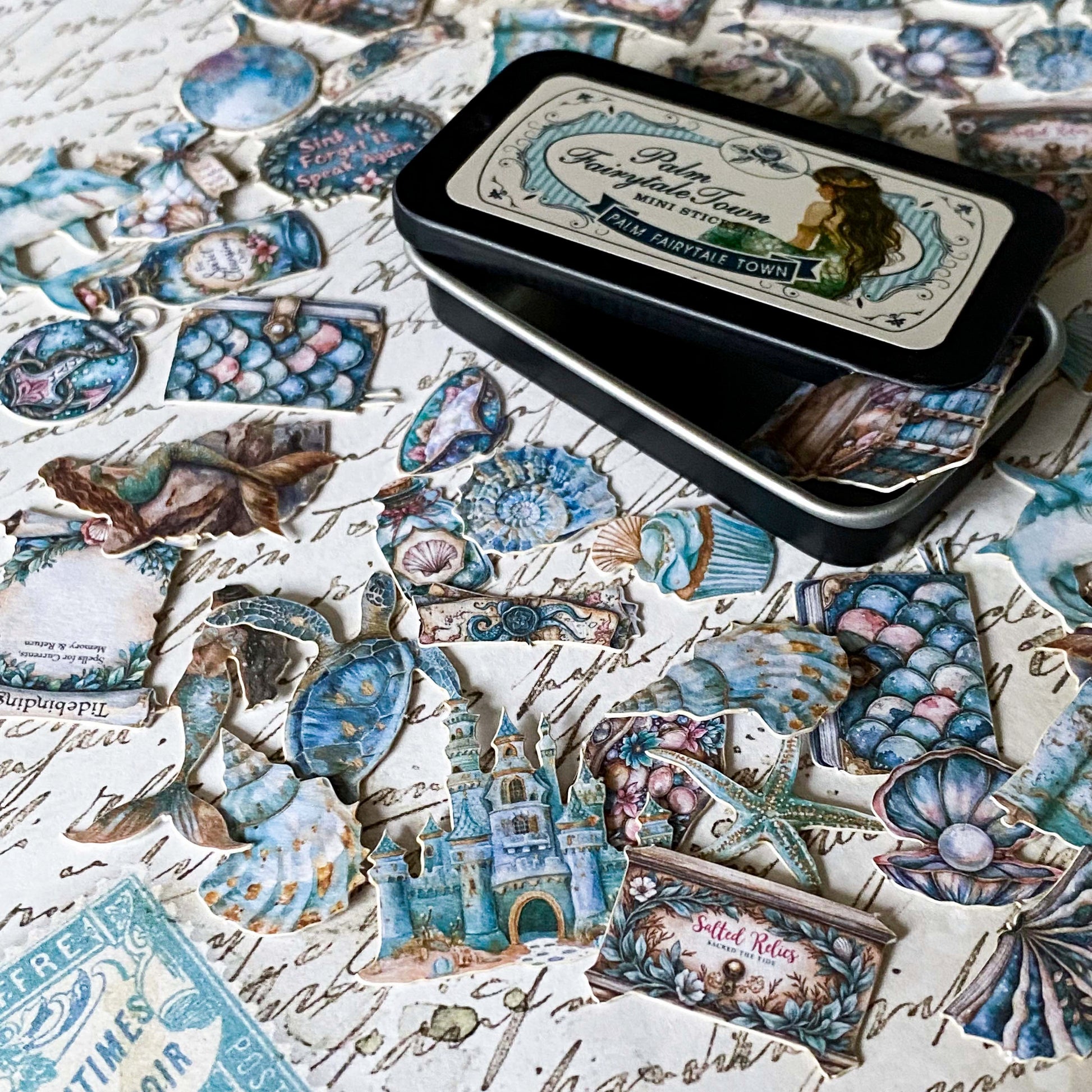 small vintage style ocean stickers spread out on a desk with seahorse, mermaid, shell and castle stickers