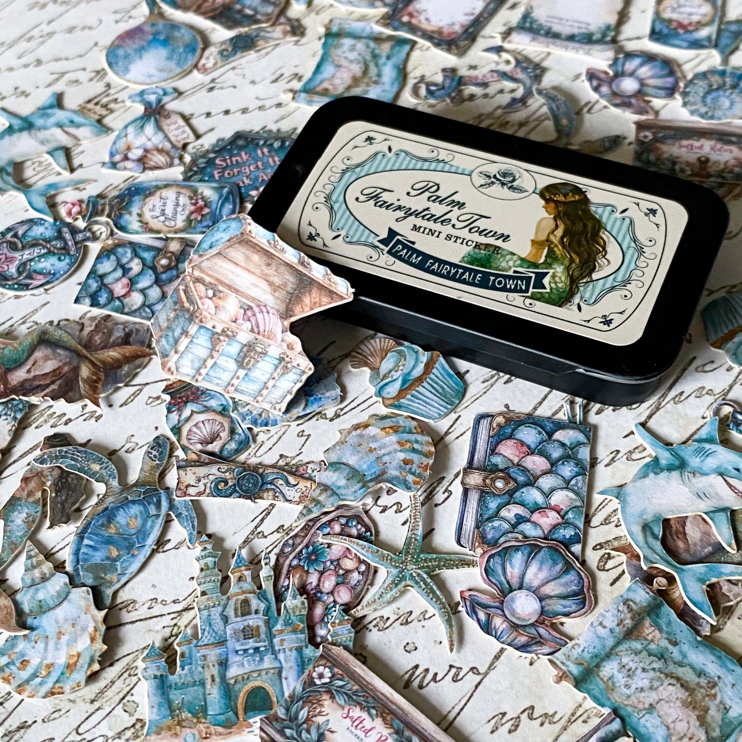 mini metal tin of mermaid themed stickers including shell designs, turtle, starfish and potion bottles