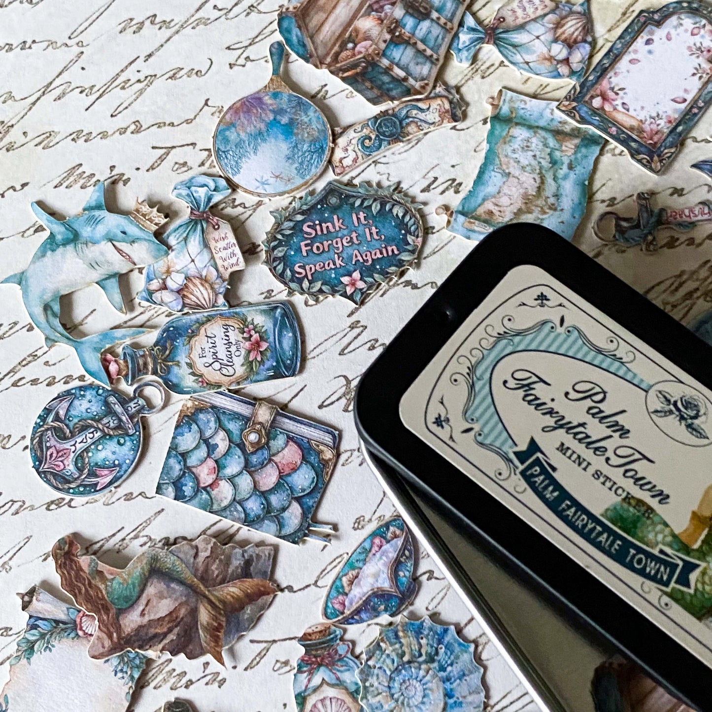 ocean themed vintage card sticker tin of 60 little stickers with blue and turquoise shells, books, potions and fish