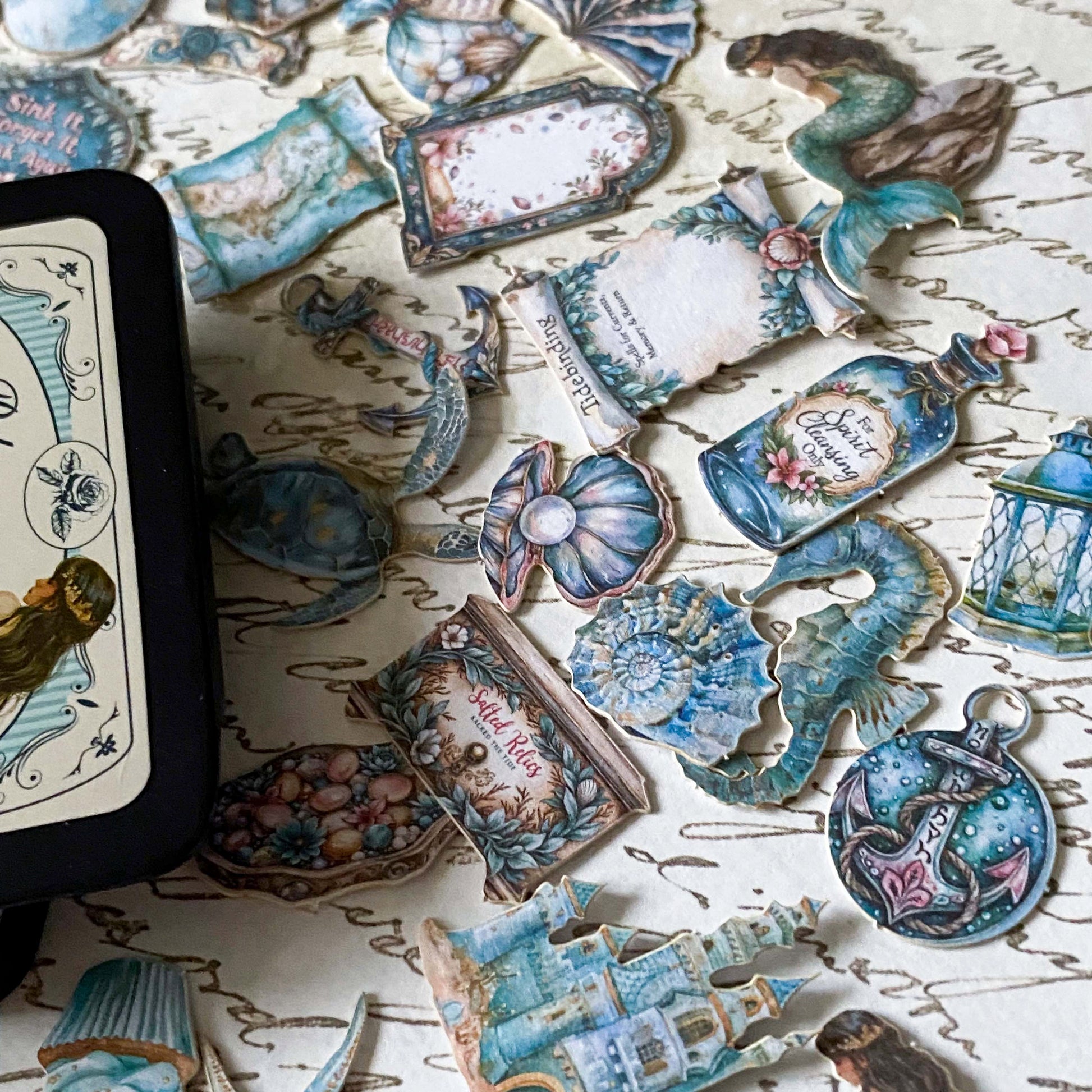 ocean themed vintage mini stickers with turquoise and soft blue green designs of shells, bottles, anchors and castles