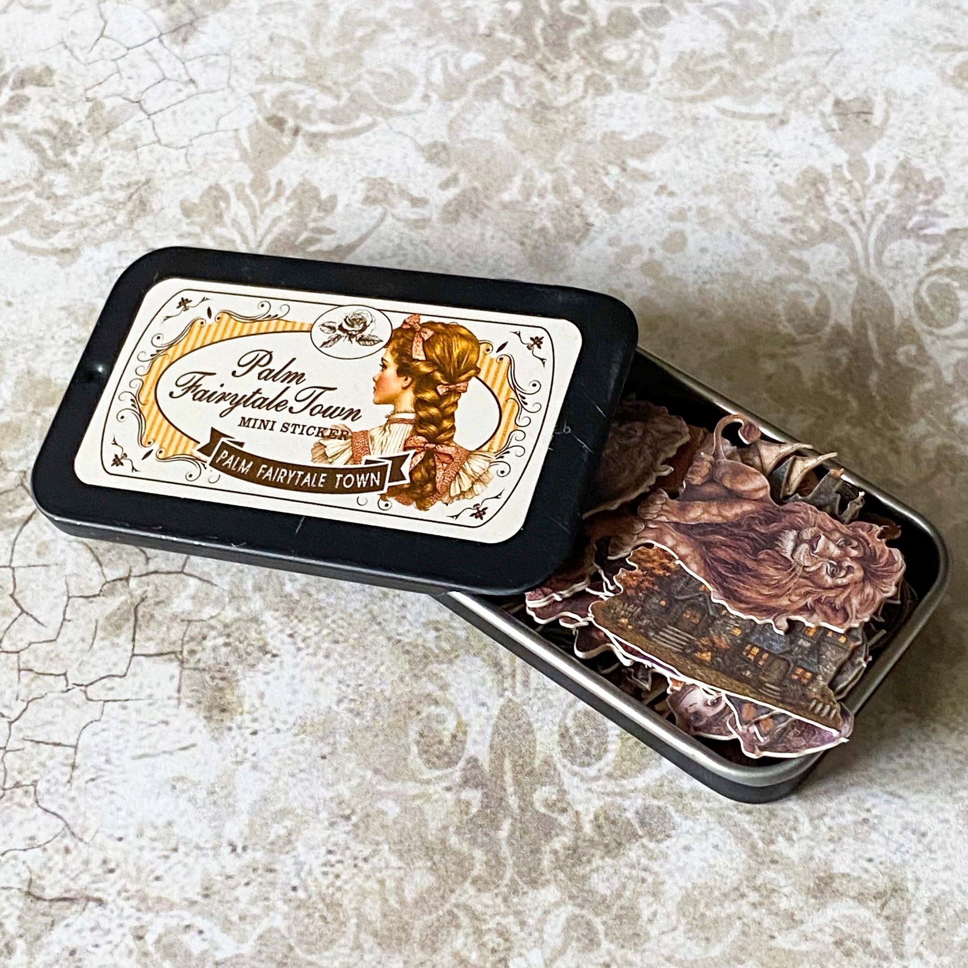 wizard of Oz themed mini sticker tin with vintage style character stickers including the lion, witch and tin man