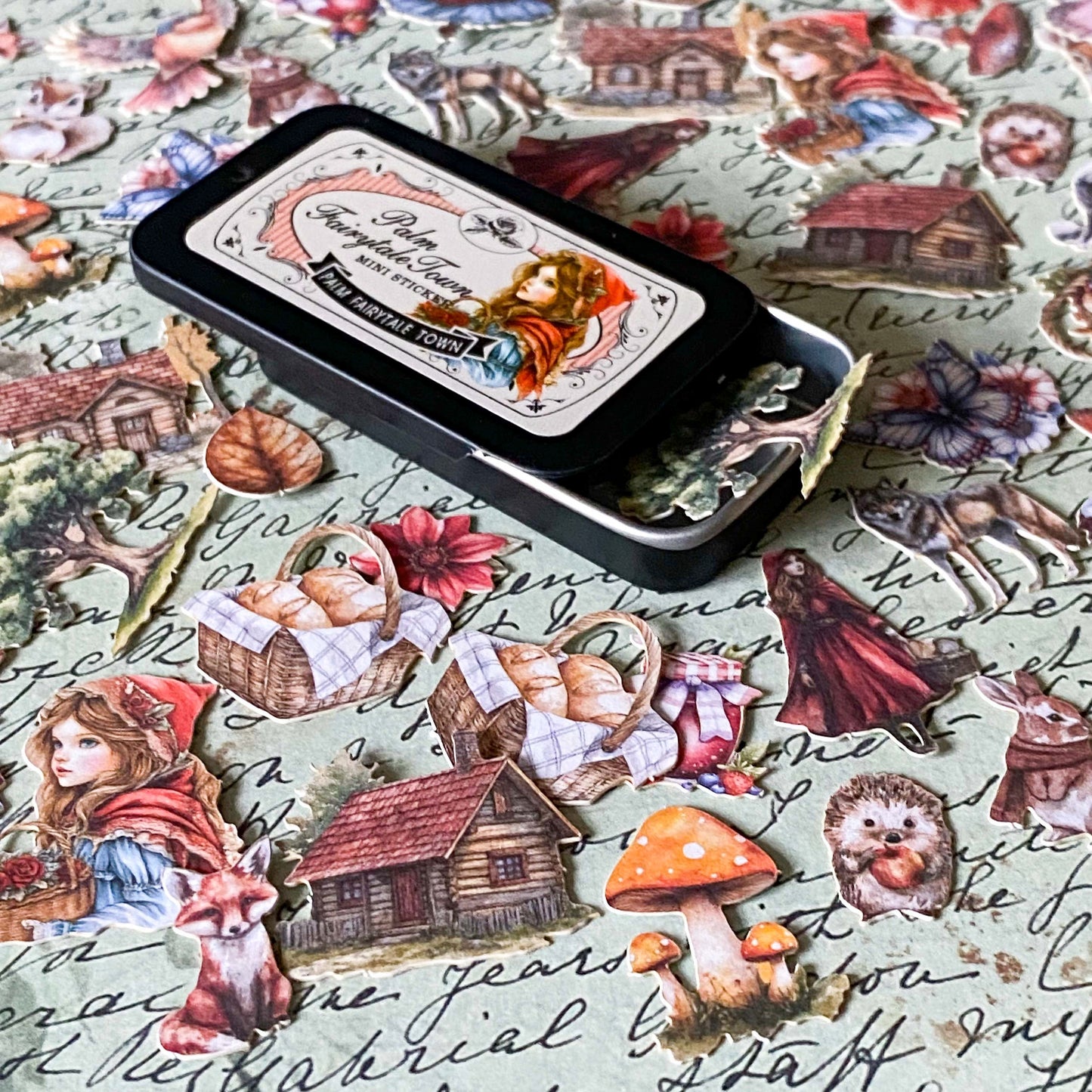 red riding hood tin of 60 small card stickers with illustrations of wolf, girl, mushrooms, cottage and forest animals