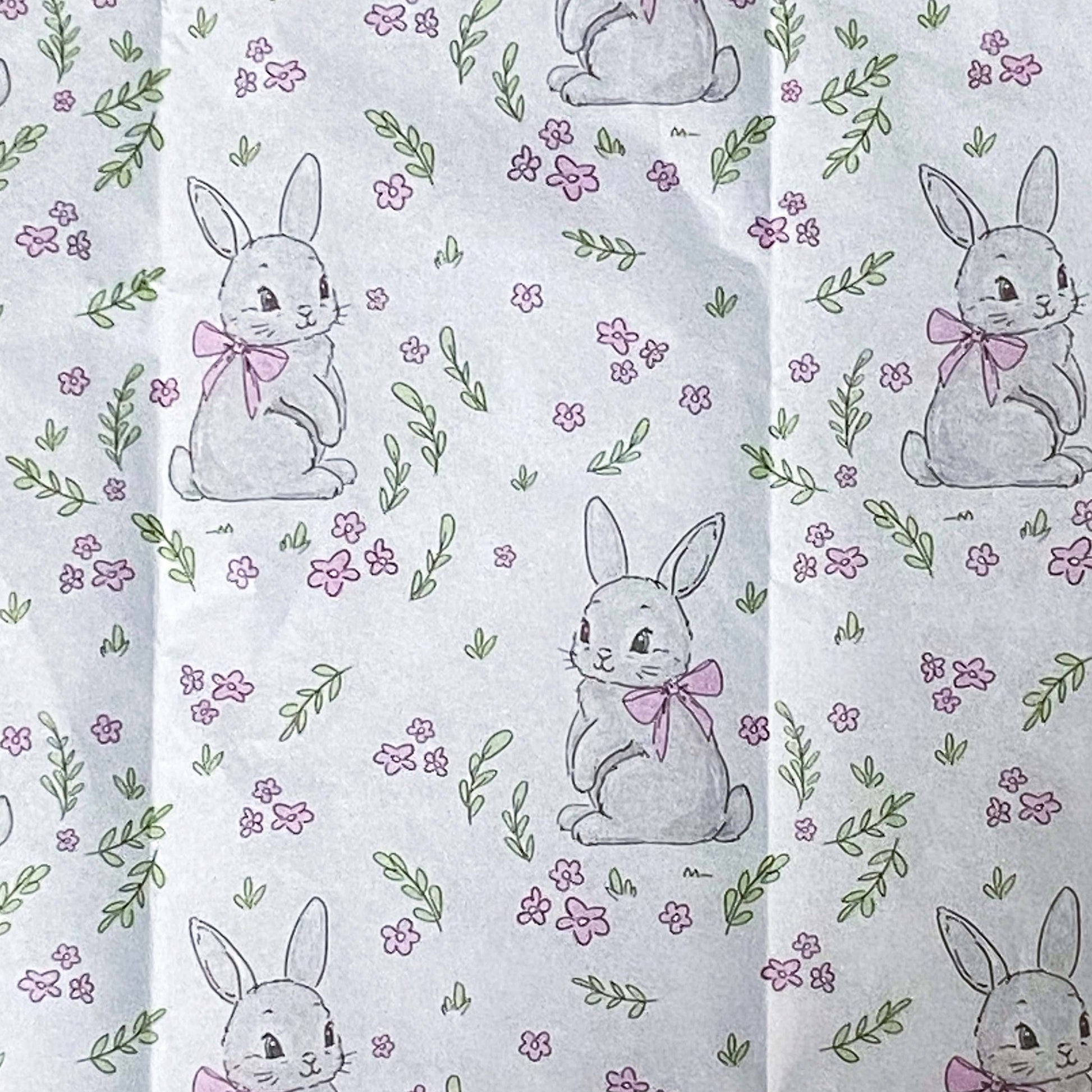 Patterned pink and white tissue paper with rabbits and flowers 