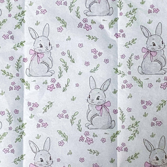Patterned pink and white tissue paper with rabbits and flowers 