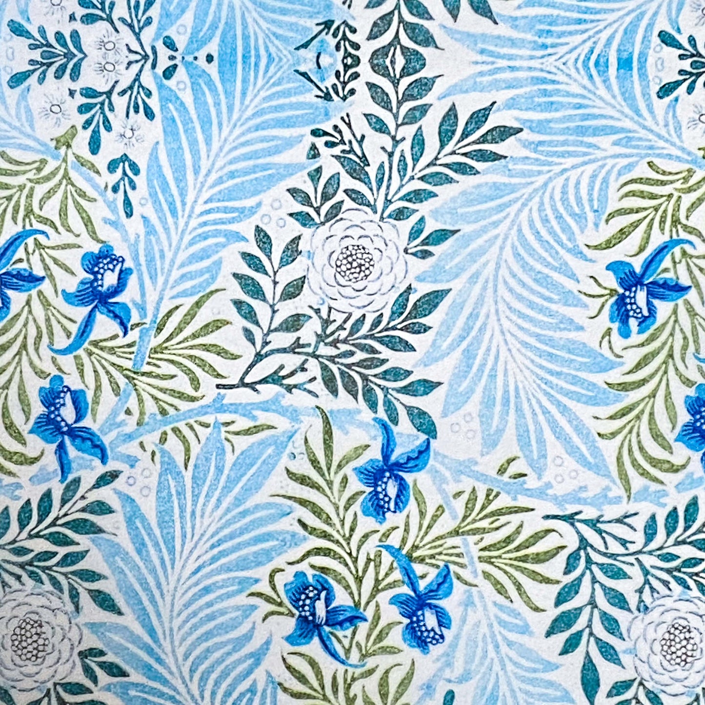  tissue paper with a with blue and green floral and leaf designs on a white background