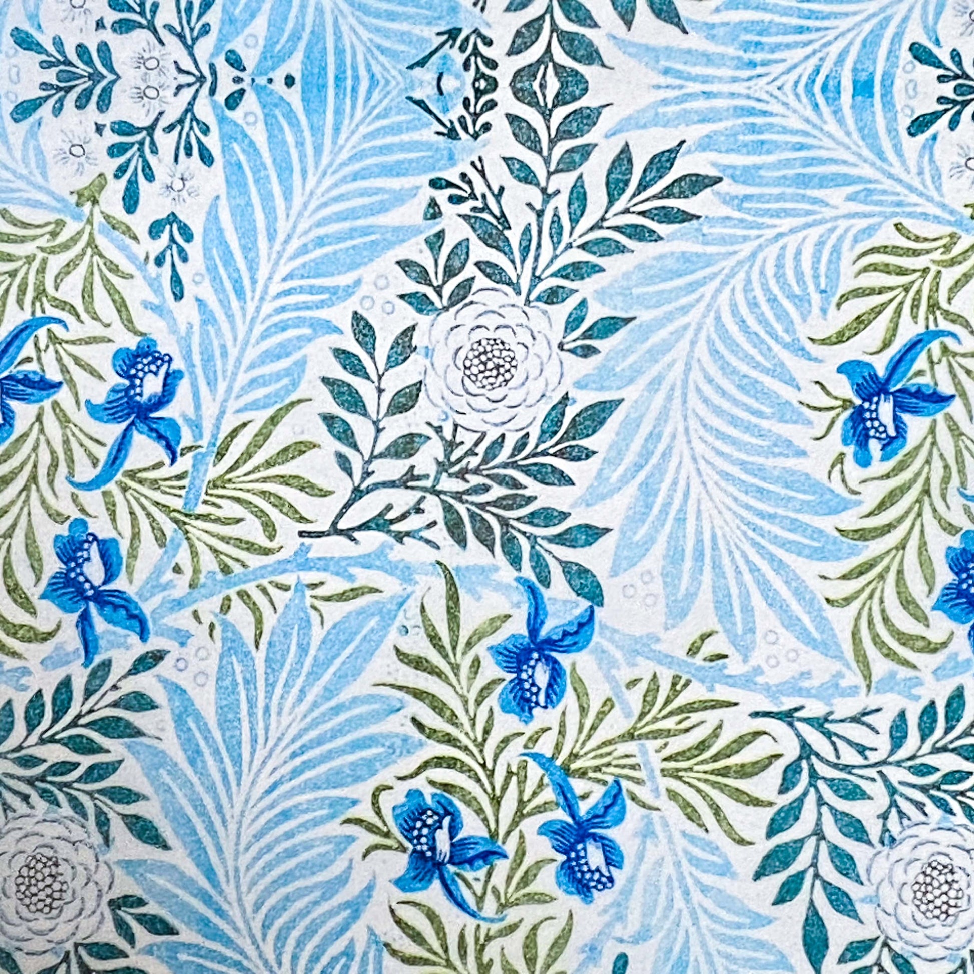  tissue paper with a with blue and green floral and leaf designs on a white background