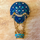 statement vintage style hot air balloon gold brooch with hanging basket and teal blue enamel