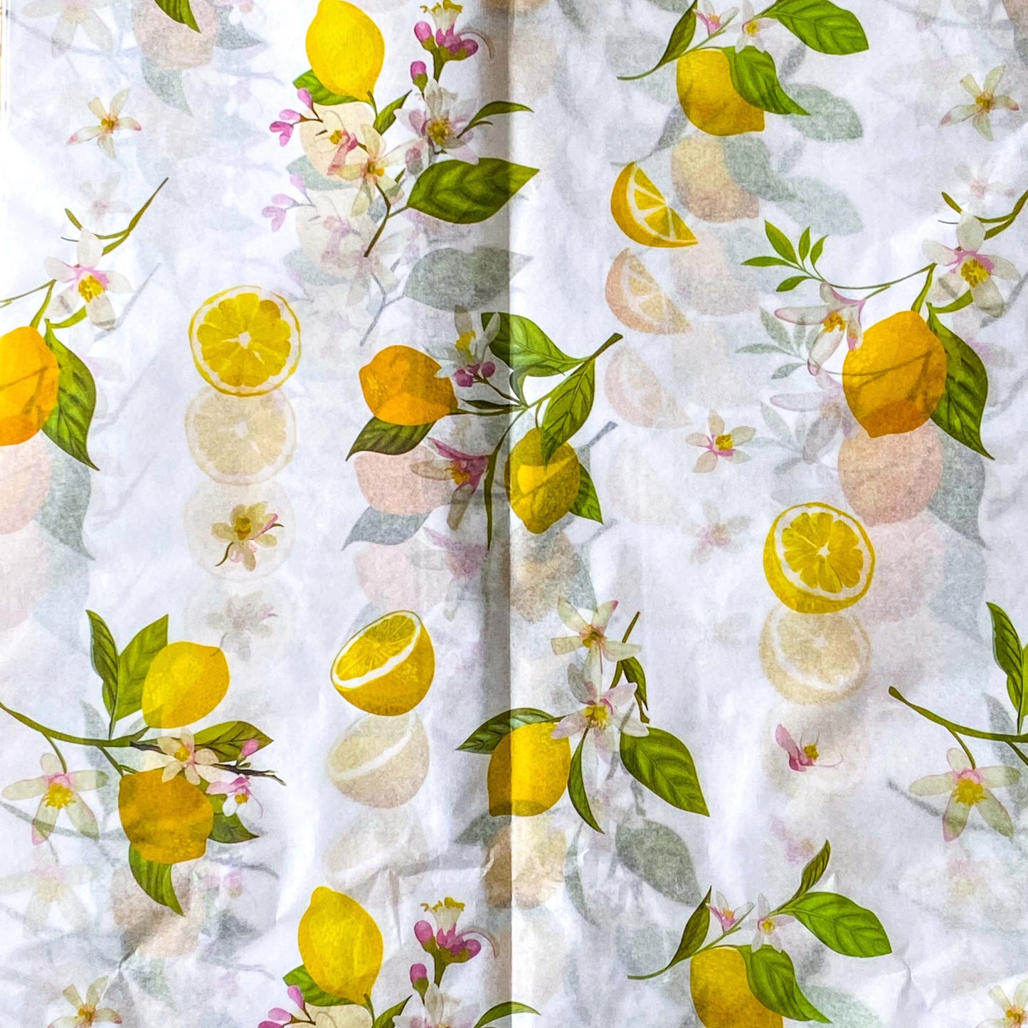 pack of 3 sheets white tissue paper with yellow lemons and pale pink blossoms with green leaves. citrus grove pattern. uk packaging supplies.