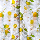 pack of 3 sheets white tissue paper with yellow lemons and pale pink blossoms with green leaves. citrus grove pattern. uk packaging supplies.