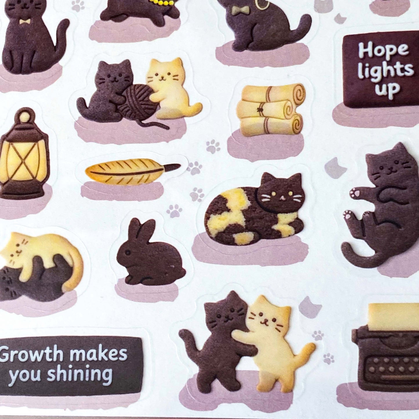 pack of dark grey and caramel coloured cat stickers with household objects and cookie shapes. Fun kawaii stationery pack of 2 transparent PET sheets.