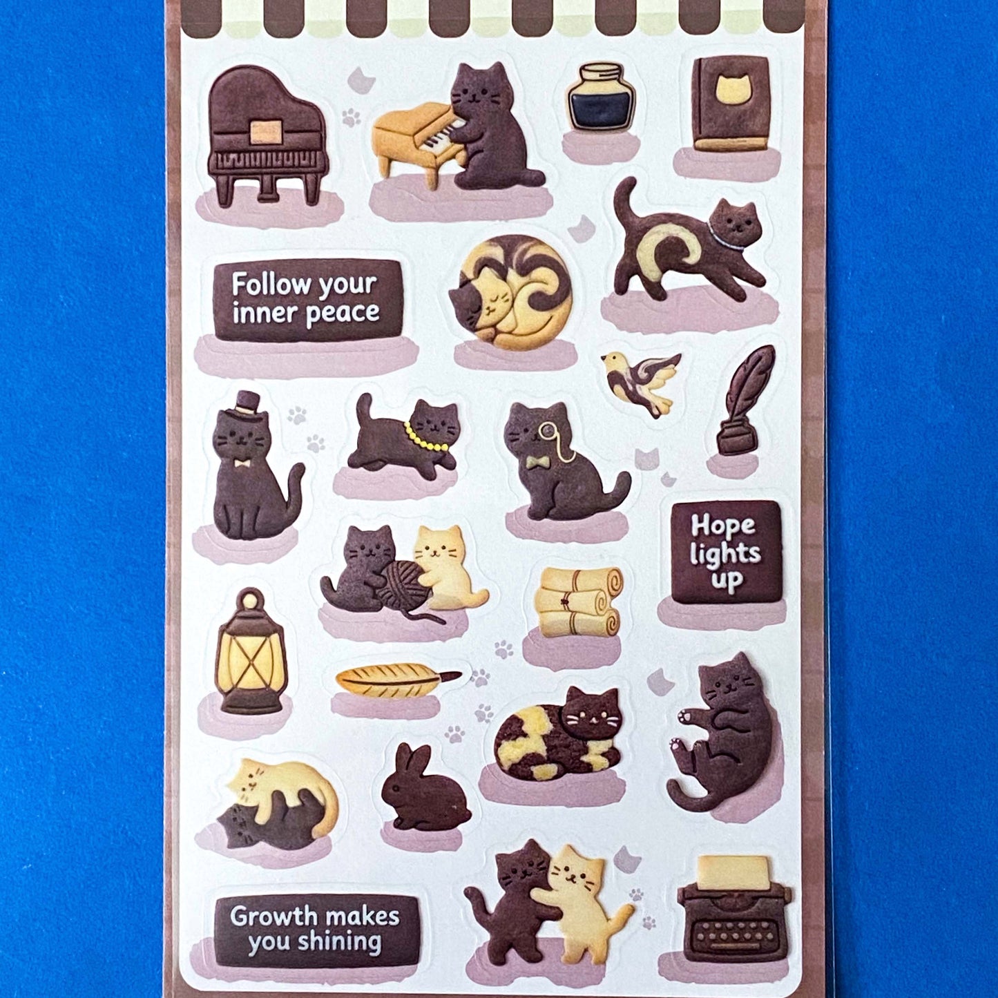 pack of dark grey and caramel coloured cat stickers with household objects and cookie shapes. Fun kawaii stationery pack of 2 transparent PET sheets.