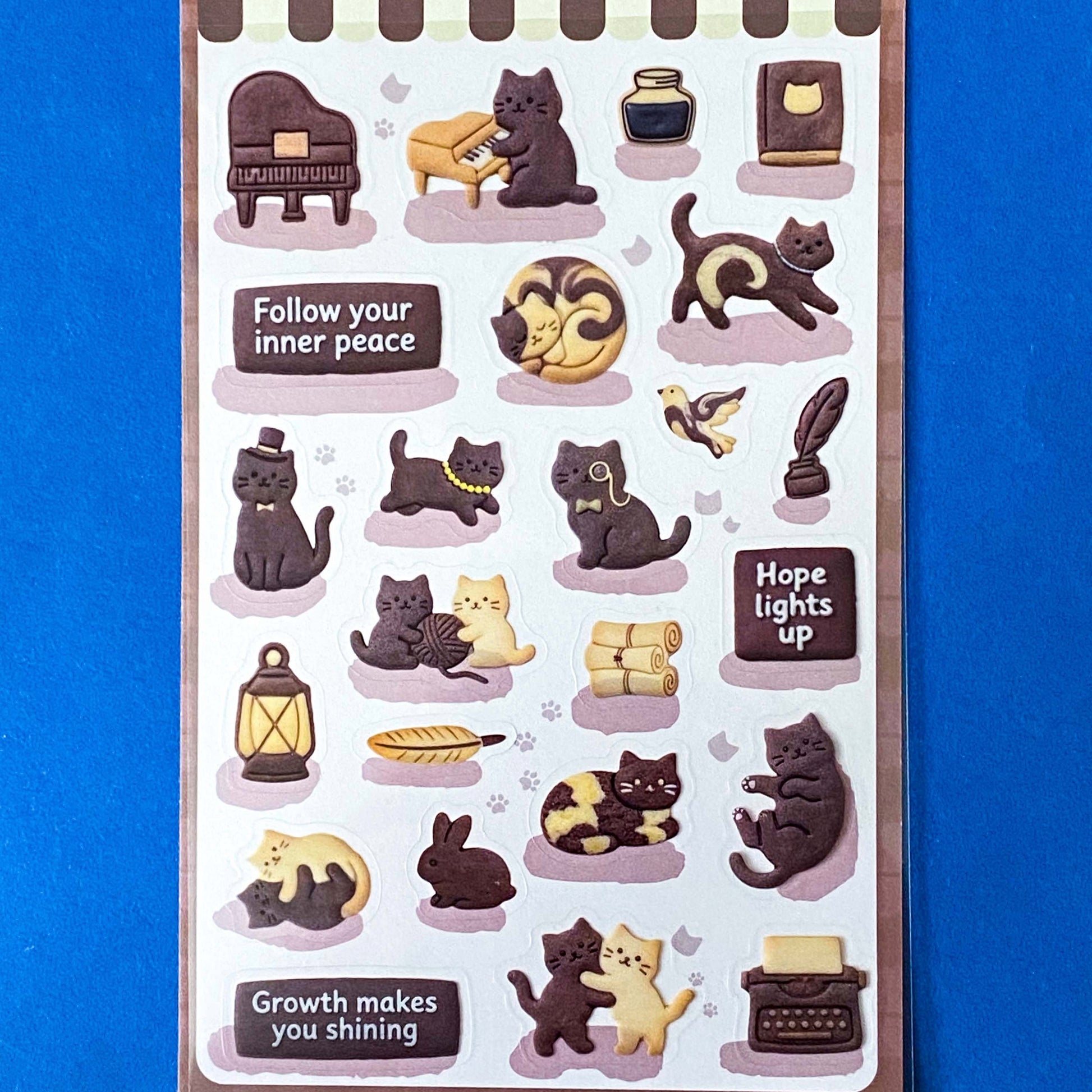 pack of dark grey and caramel coloured cat stickers with household objects and cookie shapes. Fun kawaii stationery pack of 2 transparent PET sheets.