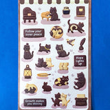 pack of dark grey and caramel coloured cat stickers with household objects and cookie shapes. Fun kawaii stationery pack of 2 transparent PET sheets.