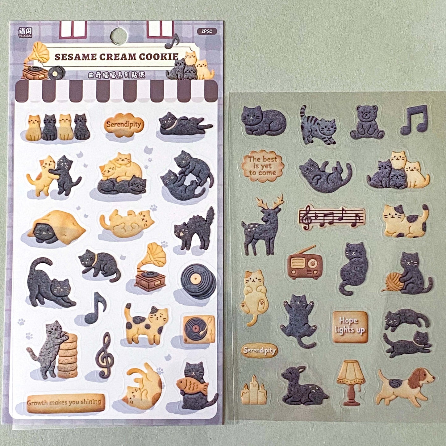 pack of dark grey and caramel coloured cat stickers with household objects and cookie shapes. Fun kawaii stationery pack of 2 transparent PET sheets.