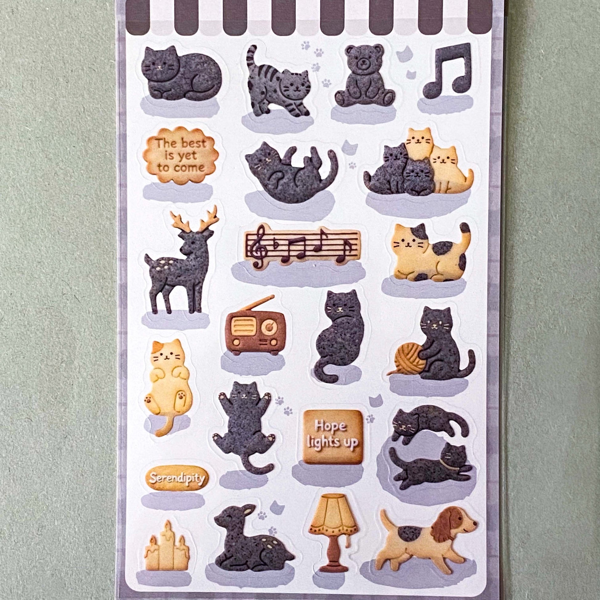 pack of dark grey and caramel coloured cat stickers with household objects and cookie shapes. Fun kawaii stationery pack of 2 transparent PET sheets.