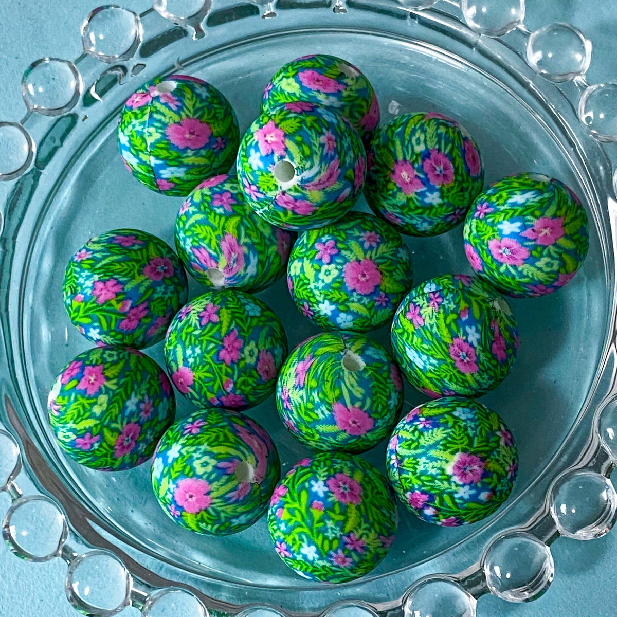 rich vibrant green and pink patterned round silicone beads 16mm with an intricate meadow flowers design.