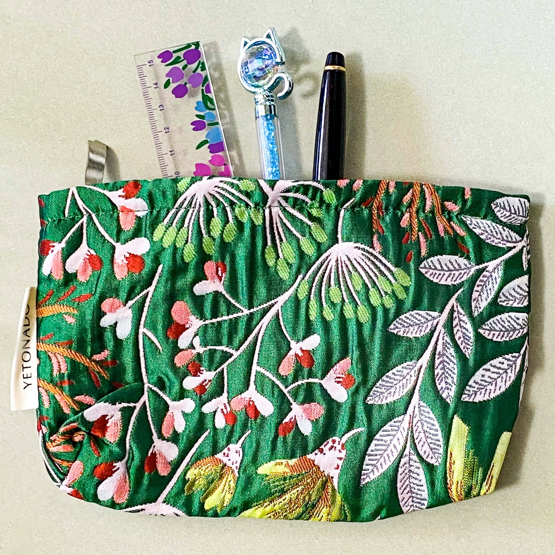 emerald green conservatory pattern woven tapestry premium make up pouch, small cosmetic bag with concealed zip and full fabric lining. rich jewel colours with flowers and leaves. uk letterbox gift