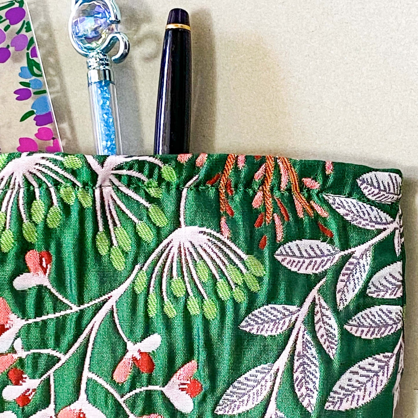 emerald green conservatory pattern woven tapestry premium make up pouch, small cosmetic bag with concealed zip and full fabric lining. rich jewel colours with flowers and leaves. uk letterbox gift