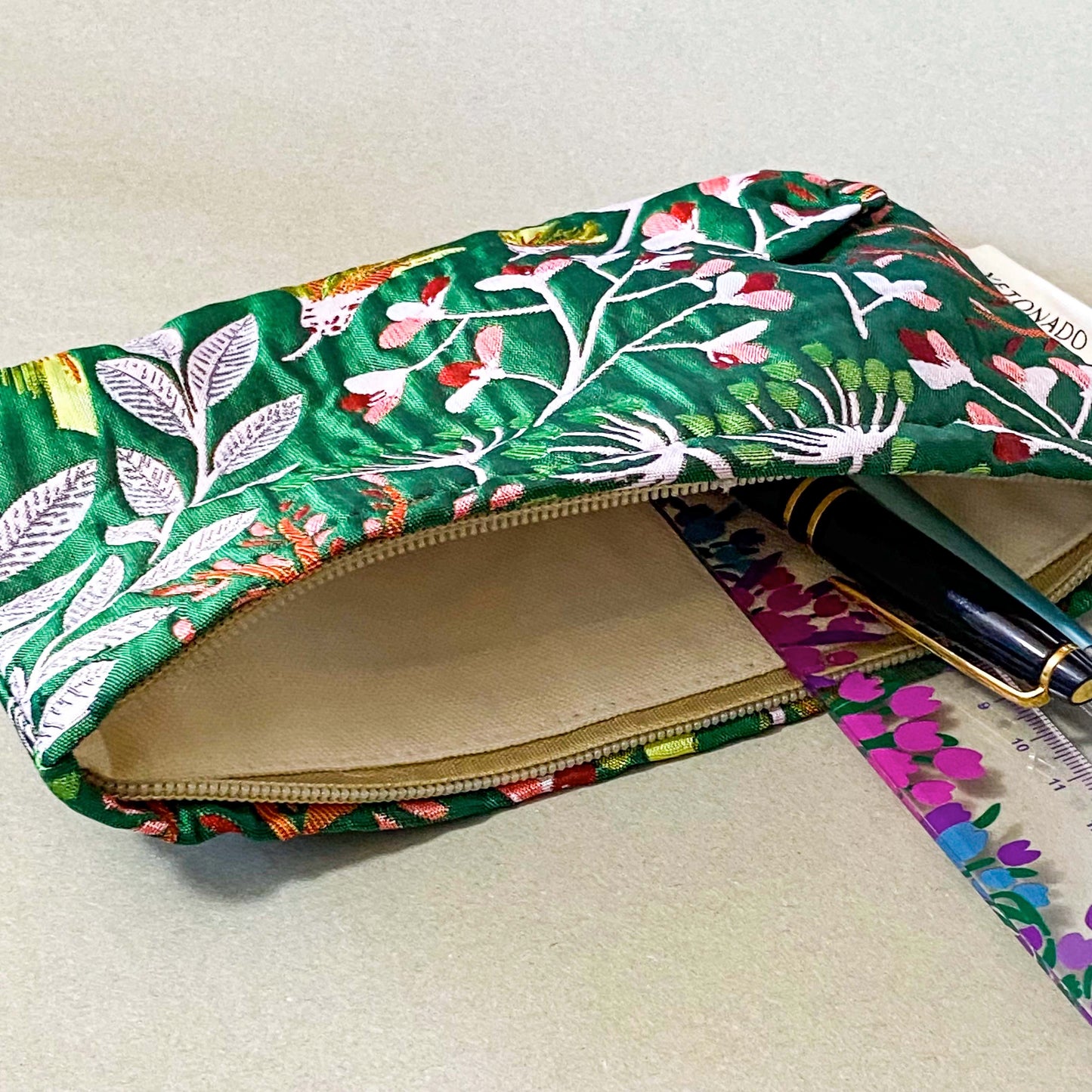 emerald green conservatory pattern woven tapestry premium make up pouch, small cosmetic bag with concealed zip and full fabric lining. rich jewel colours with flowers and leaves. uk letterbox gift