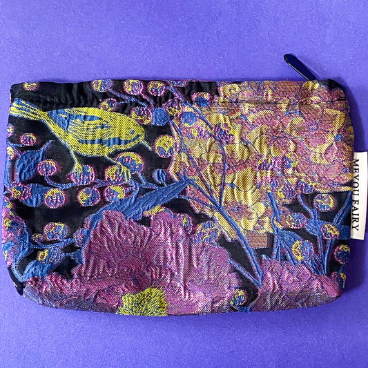 sapphire and magenta twilight luxury woven tapestry cosmetic or jewellery pouch with a sapphire blue botanical leaves and vibrant cerise florals. fully lined in black fabric and finished with a concealed zip.