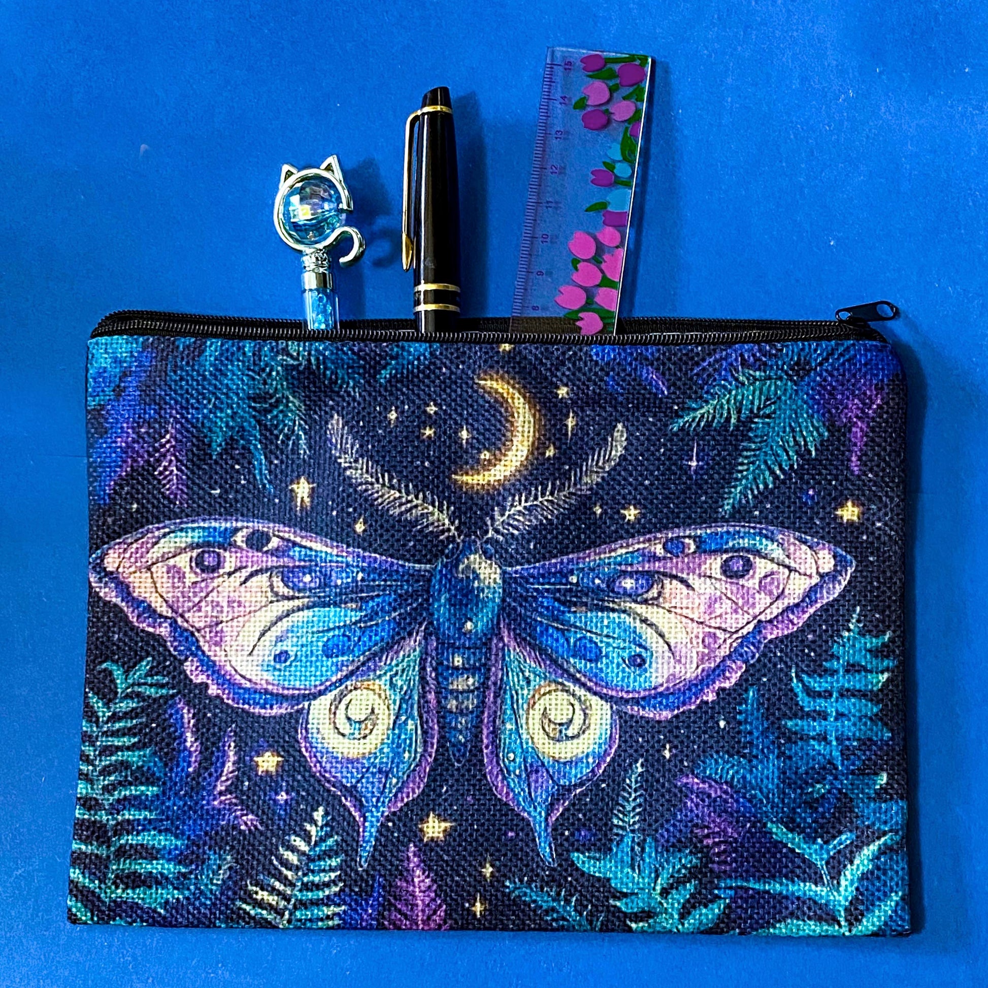 dark blue canvas zip pouch featuring a colourful luna moth beneath a crescent moon with stars and woodland ferns. Shades of lilac, purple, teal and blue. Pencil case or make up bag.
