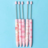 pink and white bow pattern pen blanks on a blue background