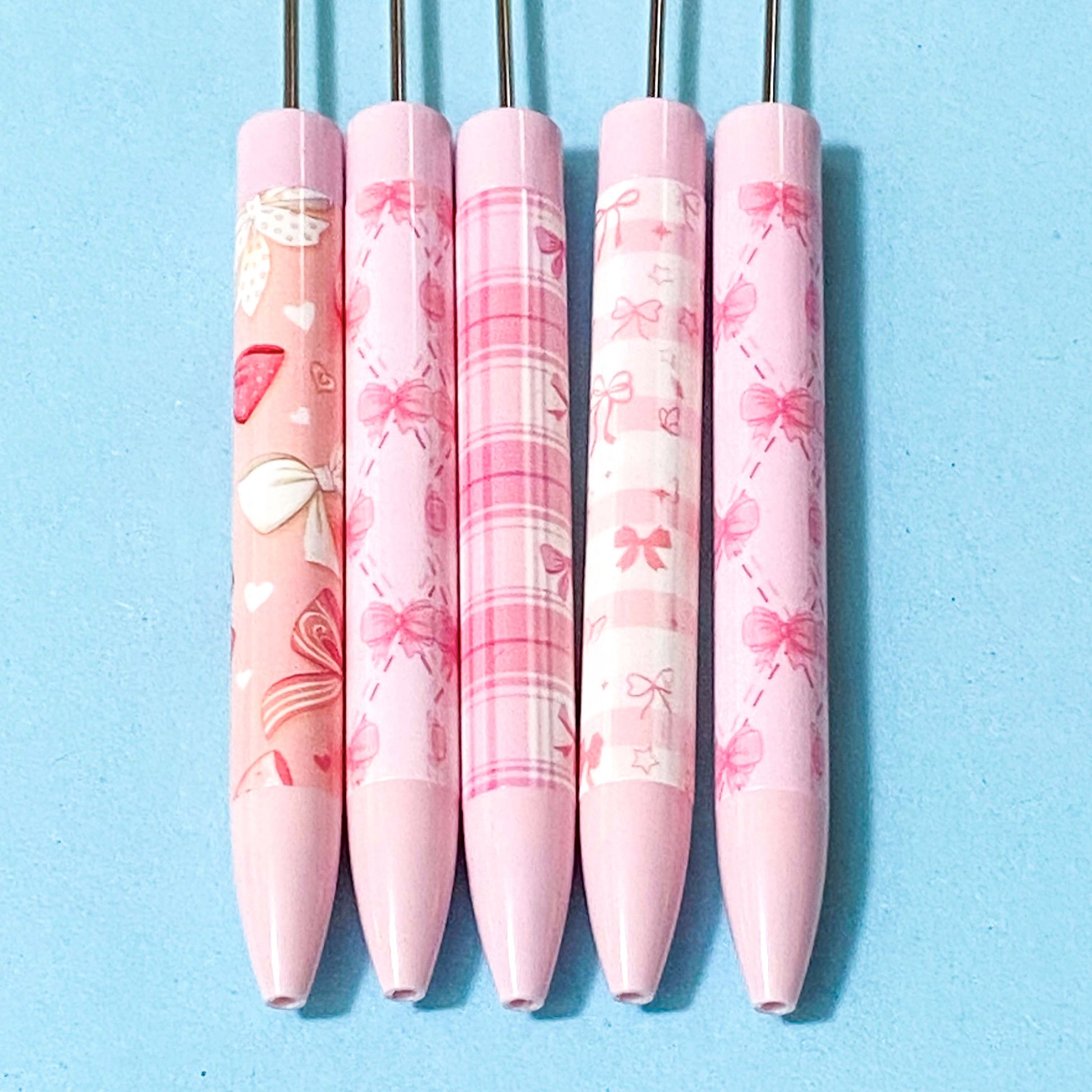 pink and peach bow pattern pen blanks on a blue background