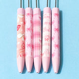 pink and peach bow pattern pen blanks on a blue background
